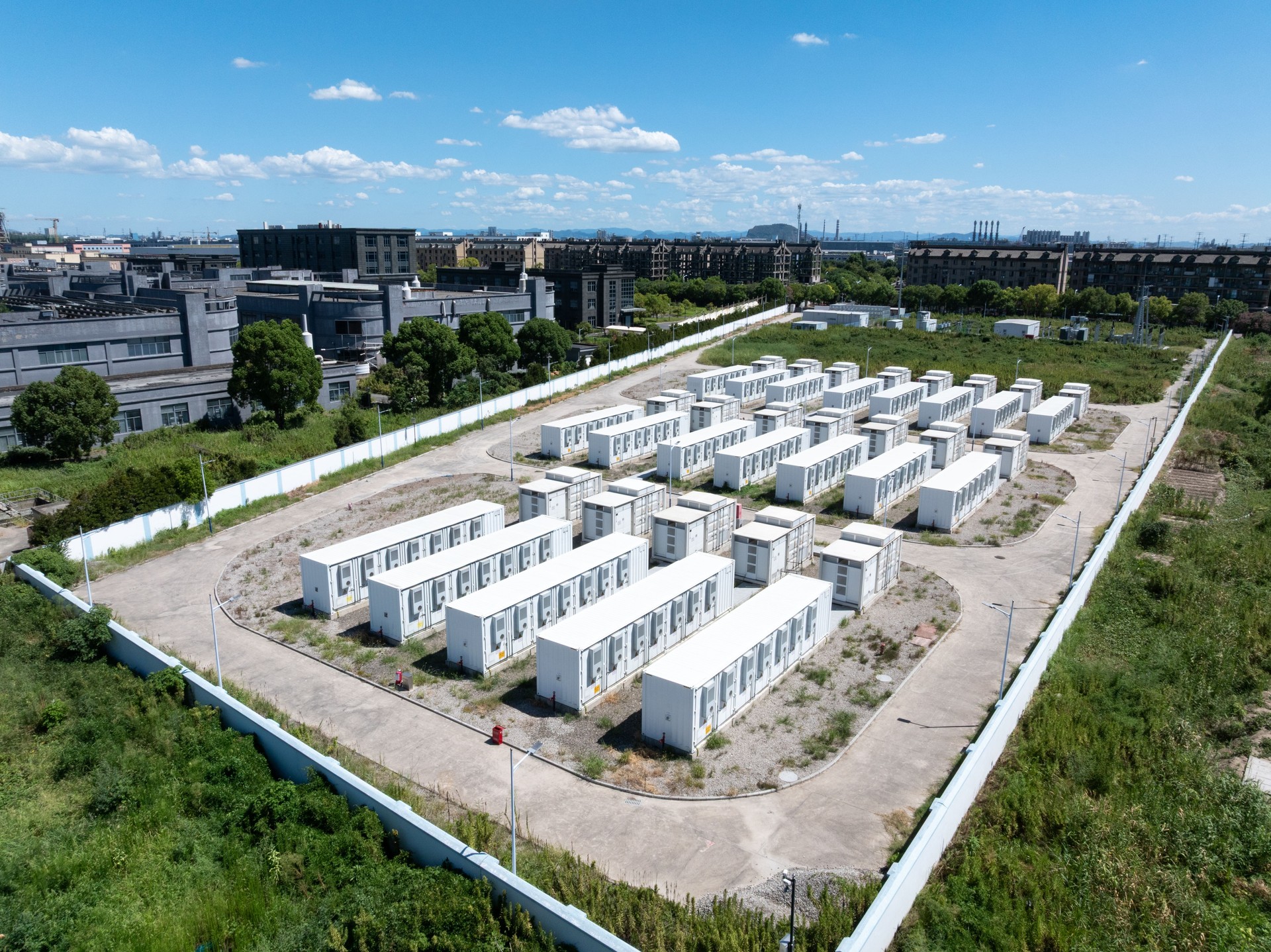 Aerial view of battery energy storage systems under a clear blue sky